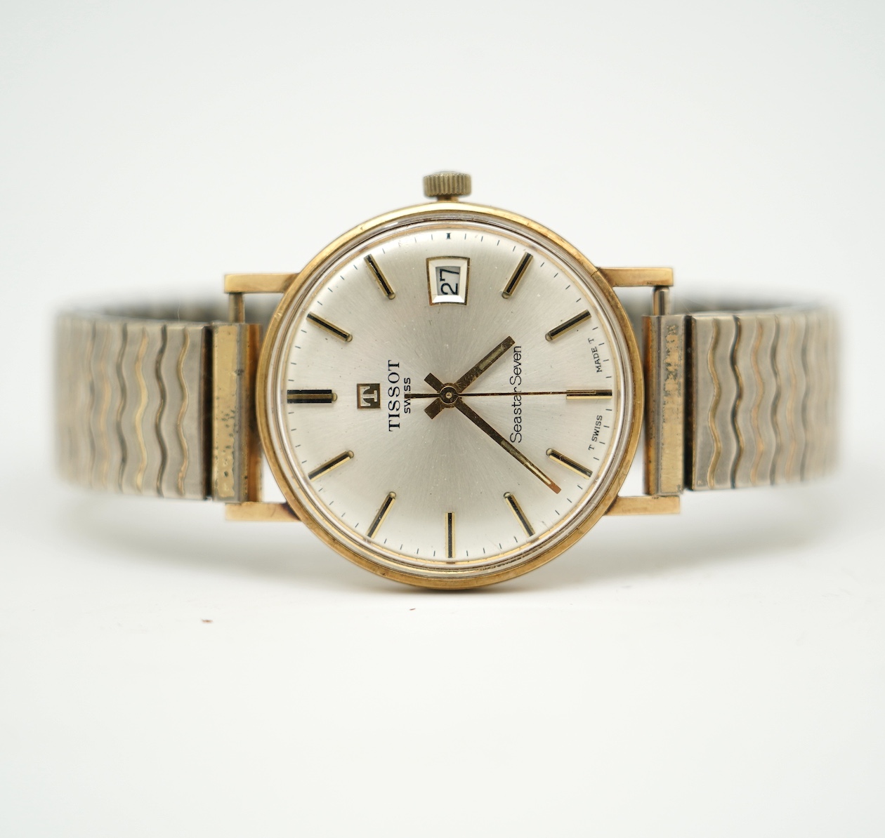 A gentleman's 1980's yellow metal Tissot Seastar Seven manual wind wrist watch, on associated flexible strap, with case back inscription. Condition - poor
